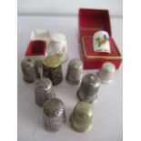 A small collection of thimbles including silver