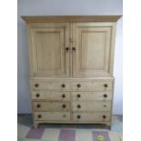 A large pine linen press with eight graduated drawers under on bracket feet - Width 153cm