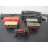 A clockwork tinplate Hornby locomotive ( 2270) with LMS livery, various carriages, track etc.