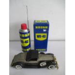 A promotional WD40 radio along with a radio in the form of a vintage car