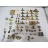 A collection of military badges, buttons etc. including a Royal Artillery silver badge and locket