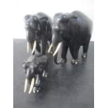A pair of ebony elephants and one other