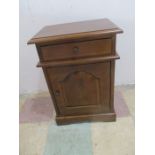 A hardwood bedside cabinet