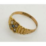 A Victorian 9ct gold ring set with a sapphire and seed pearls.