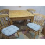 A pine dining table and four chairs