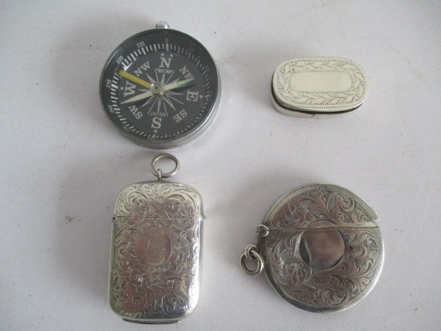 A hallmarked silver vesta along with round silver card case, snuff box and compass
