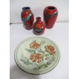 Three Poole pottery vases along with a studio pottery plate