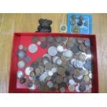 A collection of various coins along with military badges etc.