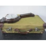 A canvas and leather suitcase along with an oak cased barometer by Broom, Reid & Harris, Exeter