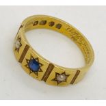 A Victorian 18ct gold ring set with a sapphire and seed pearls. Weight 4.3g