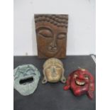 A Buddhistic panel along with three masks