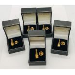 Five 9ct gold lapel pins in the form of Champagne bottles. Total gold weight 7.2g
