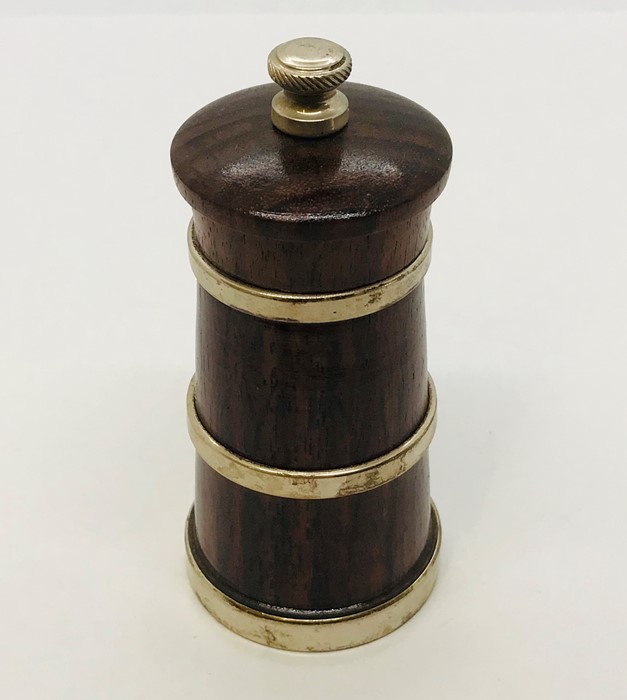 A silver banded pepper grinder