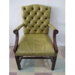A faux leather button back office chair with brass studding