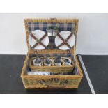 A picnic wicket basket with contents
