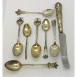 A small collection of hallmarked silver and enamel teaspoons along with a silver handled knife