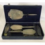 A cased hallmarked silver dressing table set. A/F