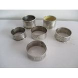 Six hallmarked silver napkin rings, some A/F