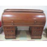 A Victorian cylinder desk with pull out and adjustable writing slope