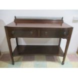 An Edwardian bow fronted buffet with pierced brass rail