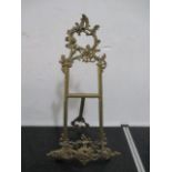 An ornate brass table easel