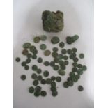 A collection of antique mainly copper coins- an intact clump of coins dug up and encrusted in mud,