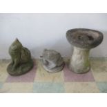 A concrete statue of a cat, a concrete frog water feature and a bird bath