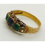 A Victorian 15ct gold ring set with Suffragette coloured stones.