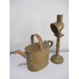A brass watering can, stamped Army & Navy to underside along with a brass candlestick with shade