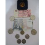 A small quantity of coins and three bank notes