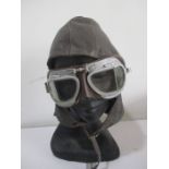 A vintage leather motorcycle hat, along with Halcyon motorcycle goggles