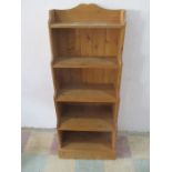 A pine waterfall effect freestanding bookcase