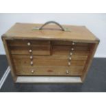 An oak tool box with 8 drawers