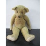 An antique teddy bear, approx 70cm height