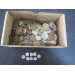 A collection of various coins including threepenny bits etc.