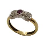 An 18ct gold bow shaped ring with ruby and diamonds