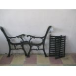 A pair of cast iron bench ends with two panels