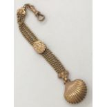 A Victorian 9ct gold Albertina chain with shell shaped fob. Weight 11.1g