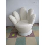 A leather swivel chair in the form of a hand