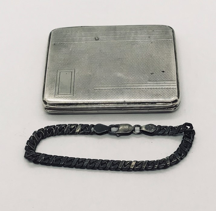 A hallmarked silver cigarette case along with a silver bracelet
