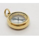 An unmarked gold compass.