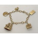 A 9ct gold charm bracelet. Weight 25.6g