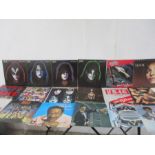 A collection of 12 inch vinyl including nine Kiss albums