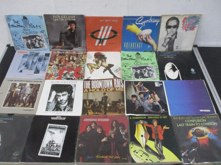 A collection of 7" vinyl singles including Wings, The Jam, Bee Gees, Deep Purple, Elton John,