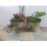 A pair of concrete garden pots