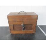 A vintage wooden toolbox with various tools and accessories including spanners, drill bits etc