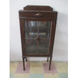 A small glazed oak display cabinet