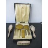 A cased Art Deco dressing table set along with 3 hallmarked silver brushes