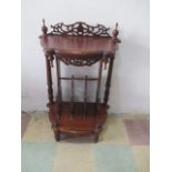 A Victorian style side table with magazine rack under