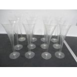 A set of twelve tall engraved champagne flutes - height 26cm